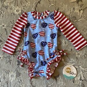 Caden Lane Ruffle Butt Patriotic Baby Rashguard  Swimsuit with Sunglasses Print
